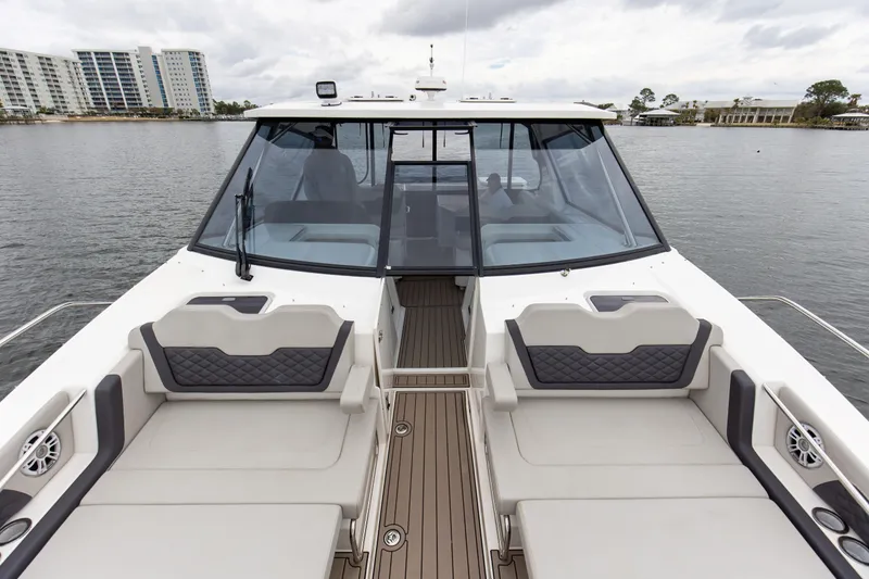Slide: The Image of 2023 Aquila 36 Sport boat with spacious seating and modern design on a calm waterway. - 44