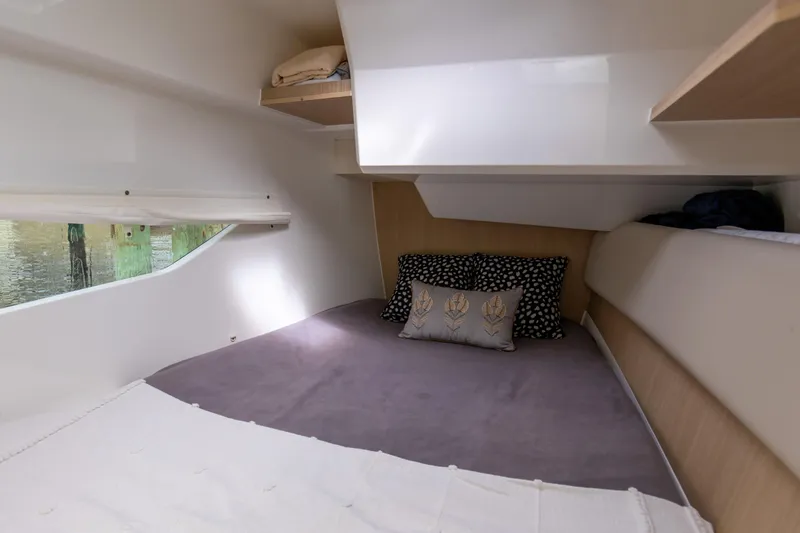 Slide: The Image of Cozy cabin interior of 2023 Aquila 36 Sport with plush bedding and decorative pillows. - 52