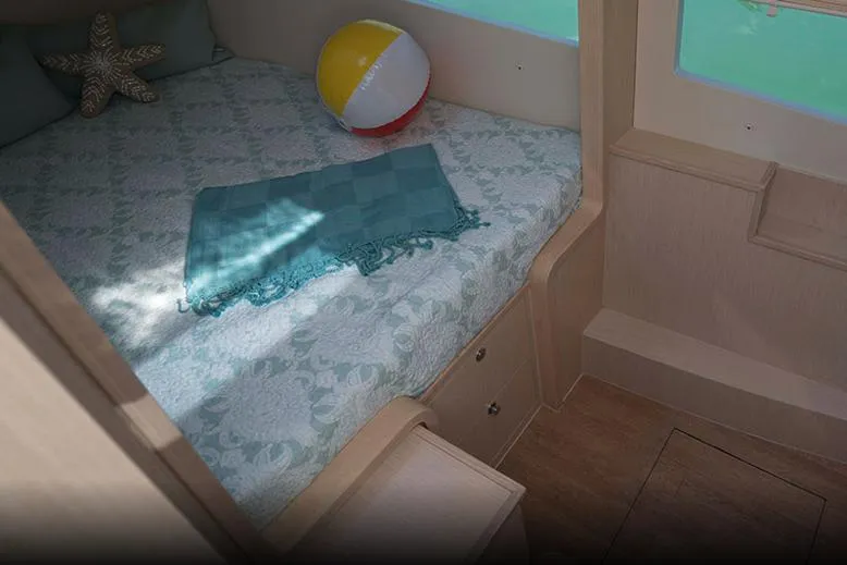 Slide: The Image of Manufacturer Provided Image: 2023 Aquila 36 Sport cabin interior with bed, beach ball, and teal blanket. - 53