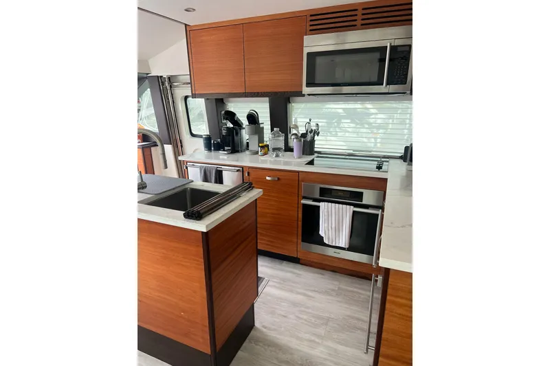 Slide: The Image of Luxurious interior of 2011 Hatteras 60 Motor Yacht with modern seating and glass doors. - 11