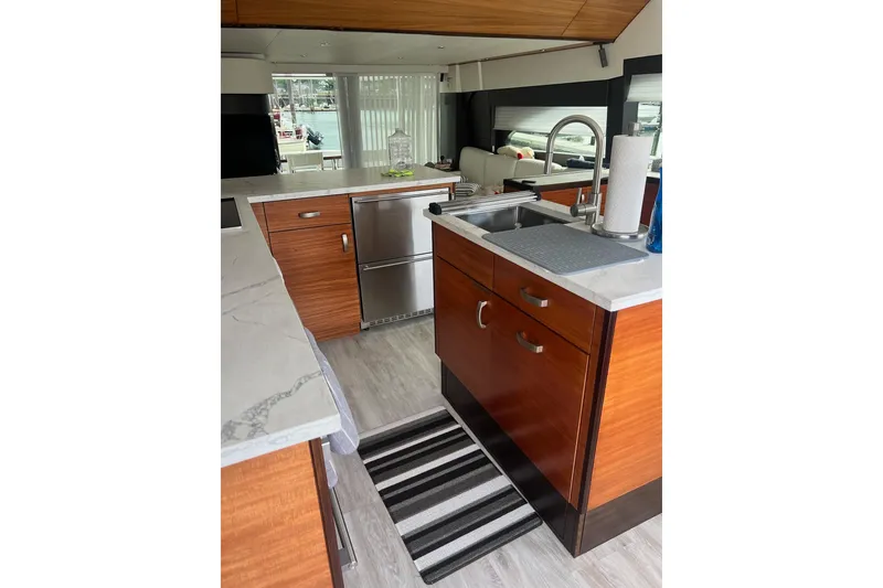 Slide: The Image of 2011 Hatteras 60 Motor Yacht docked, featuring sleek design and luxurious amenities. - 12