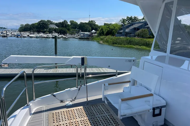 Slide: The Image of Luxurious 2011 Hatteras yacht deck with elegant seating and scenic marina view. - 19