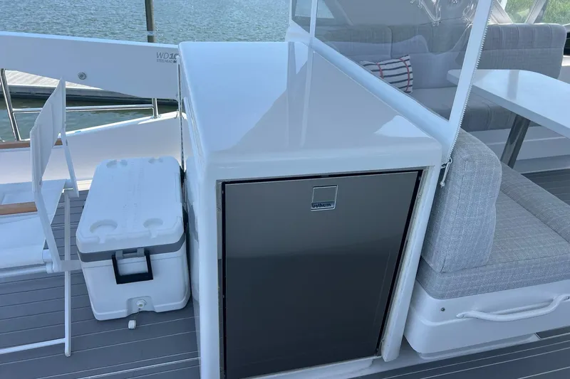 Slide: The Image of Luxury 2011 Hatteras yacht deck with seating, table, and scenic marina view. - 20