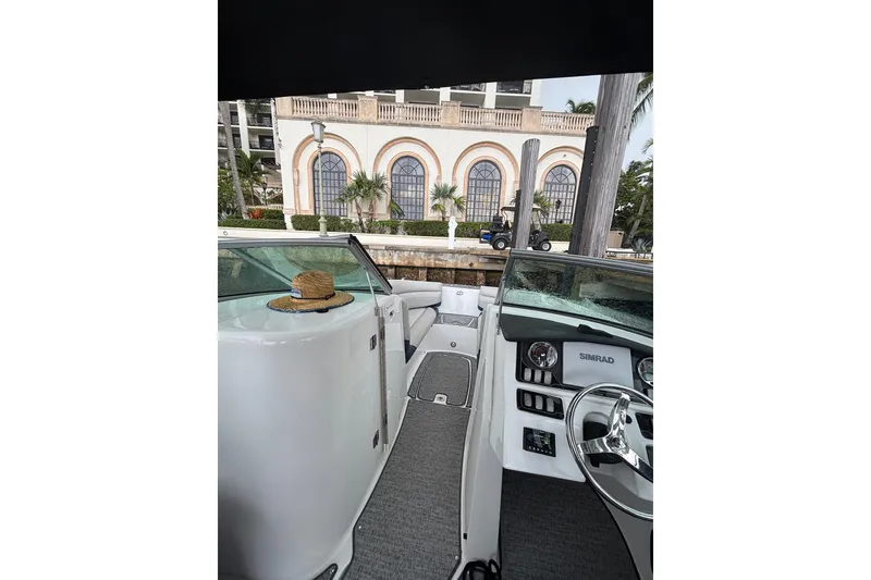 Slide: The Image of White captain's chairs on a 2011 Hatteras yacht, overlooking a marina. - 22