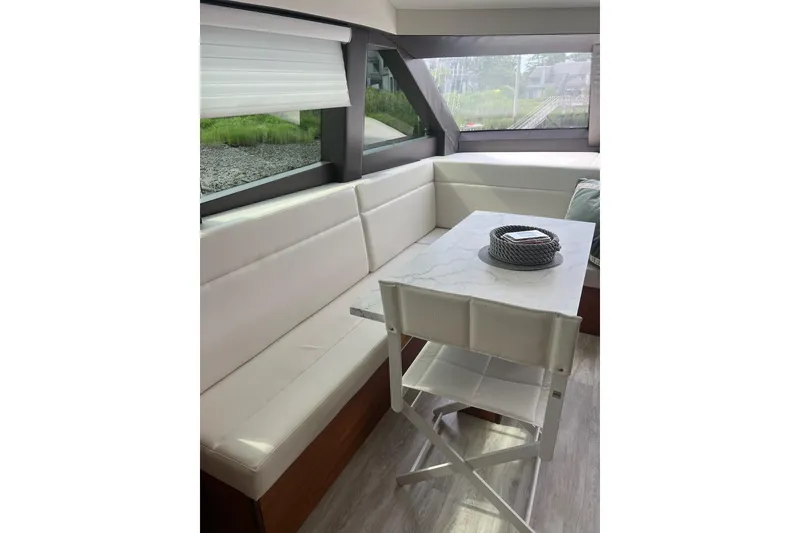 Slide: The Image of Luxury white seating on a 2011 Hatteras yacht with scenic marina view. - 23