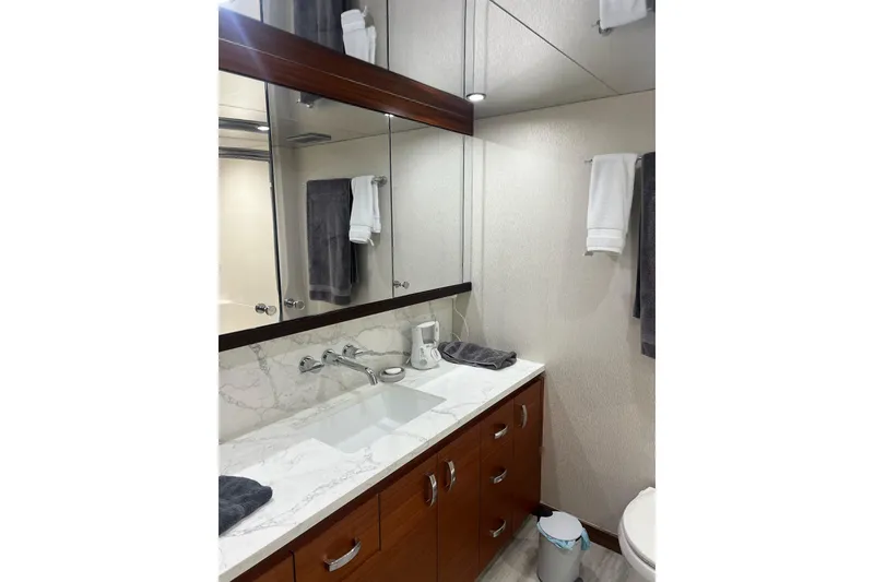 Slide: The Image of 2011 Hatteras yacht interior with seating, cooler, and mini fridge on deck. - 26