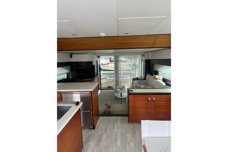 Slide: The Image of Luxurious interior of 2011 Hatteras 60 Motor Yacht with modern kitchen and dining area. - 29