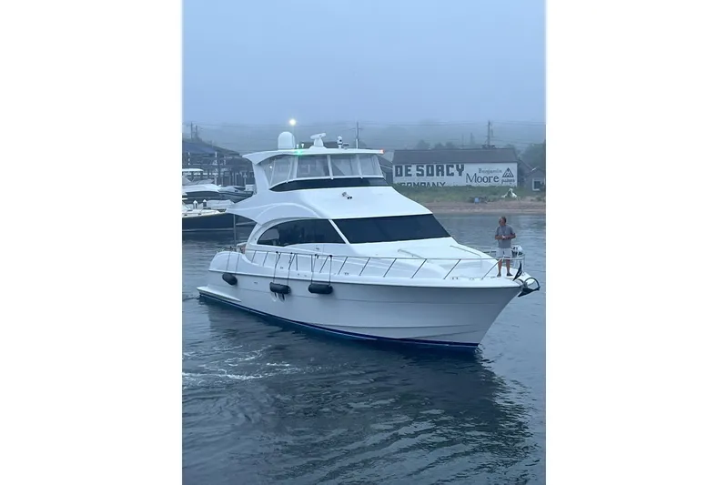 Slide: The Image of Wine cooler inside 2011 Hatteras 60 Motor Yacht, featuring wooden shelves and sleek design. - 30
