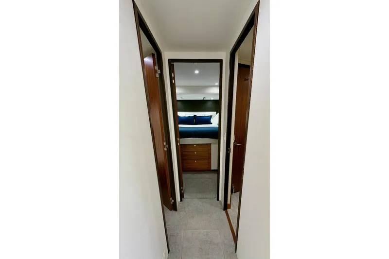 Slide: The Image of Staircase inside 2011 Hatteras 60 Motor Yacht with sunset artwork on wall. - 32