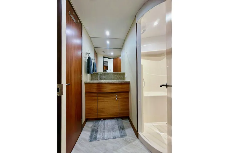 Slide: The Image of Luxurious bedroom interior of 2011 Hatteras 60 Motor Yacht with porthole windows and modern decor. - 35