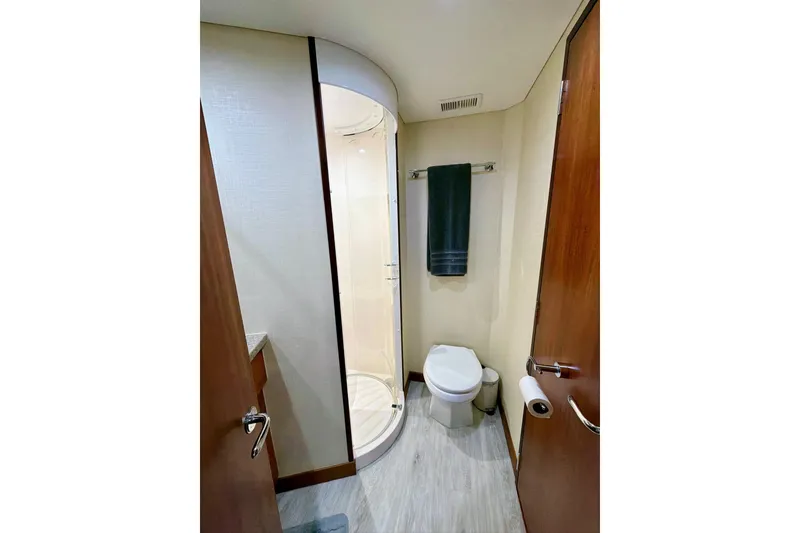 Slide: The Image of Luxurious bathroom in 2011 Hatteras 60 Motor Yacht with modern fixtures and wood cabinetry. - 43
