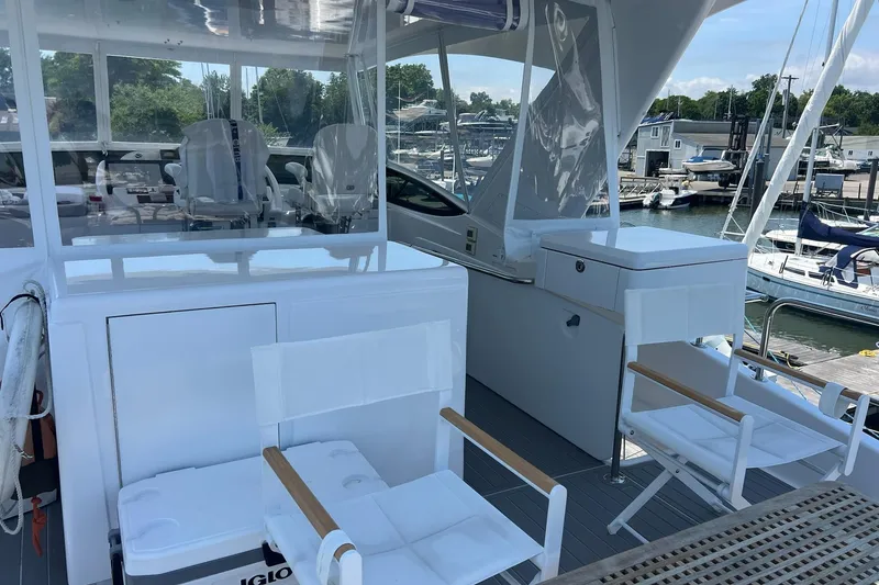 Slide: The Image of 2011 Hatteras 60 Motor Yacht cruising on a sunny day, surrounded by palm trees. - 5