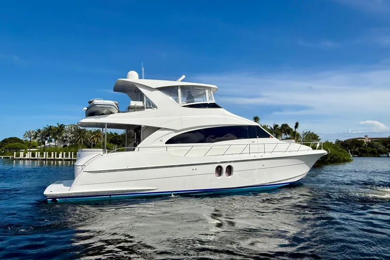 Slide: The Image of 2011 Hatteras 60 Motor Yacht on calm water under clear blue sky. - 50