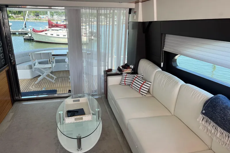 Slide: The Image of 2011 Hatteras 60 Motor Yacht docked, rear view with palm trees and waterway. - 8