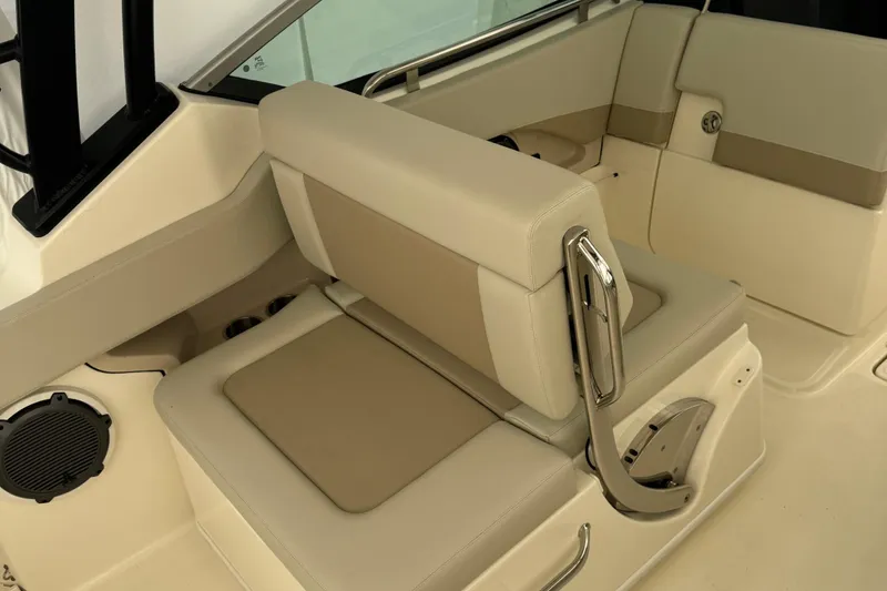Slide: The Image of 2022 Boston Whaler 240 Vantage interior seating with beige upholstery and stainless steel accents. - 13