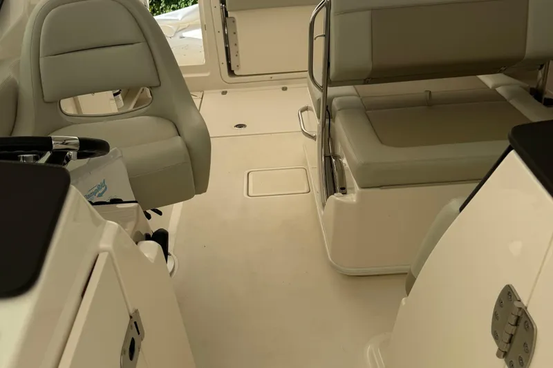 Slide: The Image of 2022 Boston Whaler 240 Vantage interior with beige seating and sleek design. - 14