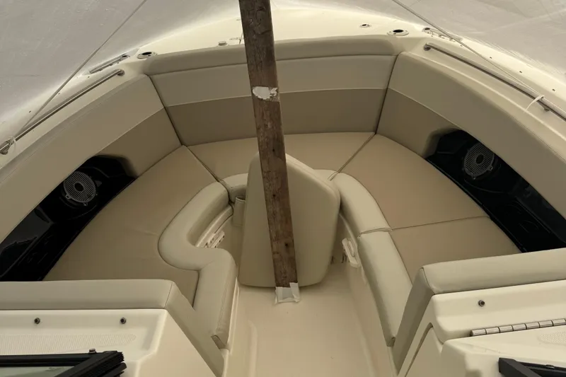 Slide: The Image of 2022 Boston Whaler 240 Vantage boat interior with beige seating and speakers. - 15