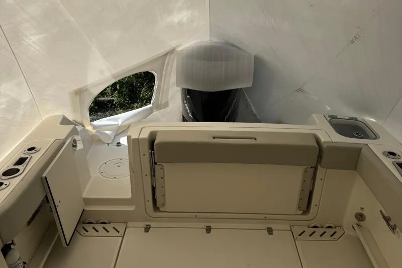 Slide: The Image of 2022 Boston Whaler 240 Vantage boat interior with seating and storage compartments. - 17