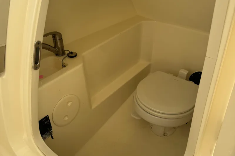 Slide: The Image of 2022 Boston Whaler 240 Vantage boat interior bathroom with toilet and sink. - 18