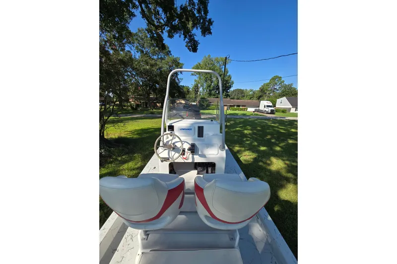 Slide: The Image of 2019 Gulf Coast Pro 22 boat with dual seats and steering console in a grassy yard. - 11