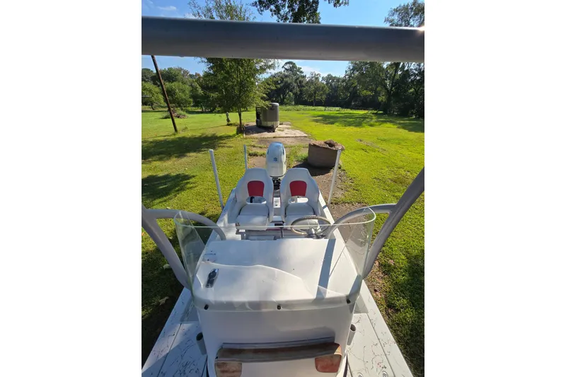 Slide: The Image of 2019 Gulf Coast Pro 22 boat on grassy landscape, rear view. - 13