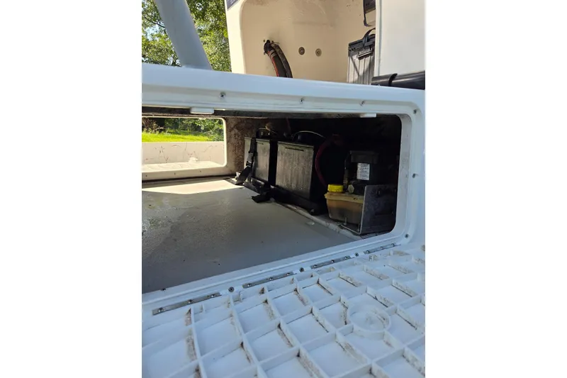Slide: The Image of 2019 Gulf Coast Pro 22 boat storage compartment with battery and equipment. - 14