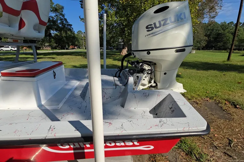 Slide: The Image of 2019 Gulf Coast Pro 22 boat with Suzuki outboard motor in a grassy area. - 16