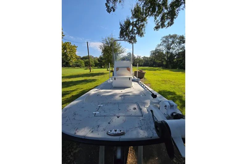 Slide: The Image of 2019 Gulf Coast Pro 22 boat on grassy landscape under clear blue sky. - 7