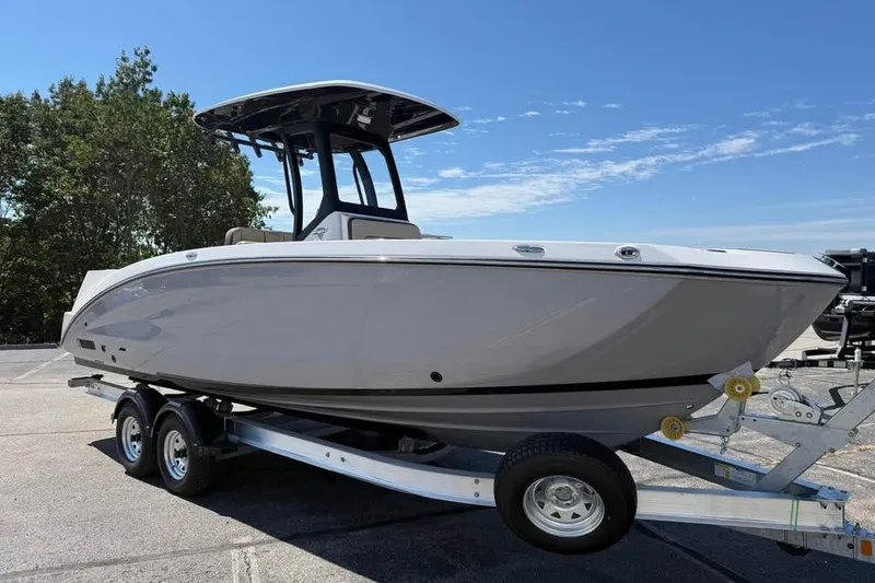Slide: The Image of 2026 Yamaha Boats 255 FSH Sport H on trailer, parked outdoors under clear sky. - 1