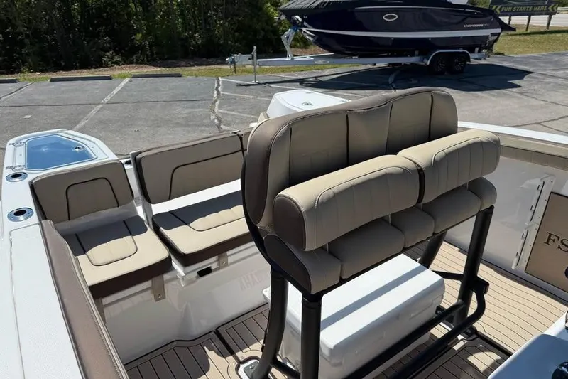 Slide: The Image of 2026 Yamaha Boats 255 FSH Sport H interior with beige seating and modern design. - 11