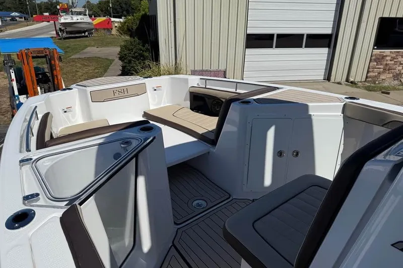 Slide: The Image of 2026 Yamaha Boats 255 FSH Sport H interior with seating and storage compartments. - 13