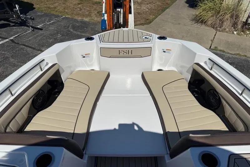 Slide: The Image of 2026 Yamaha Boats 255 FSH Sport H interior with beige seating and FSH logo. - 14