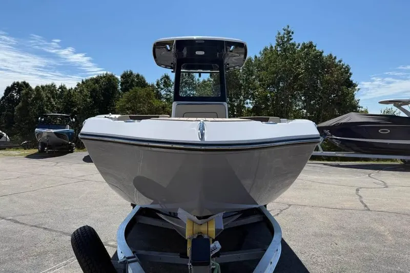 Slide: The Image of 2026 Yamaha Boats 255 FSH Sport H on trailer, parked outdoors under clear sky. - 2