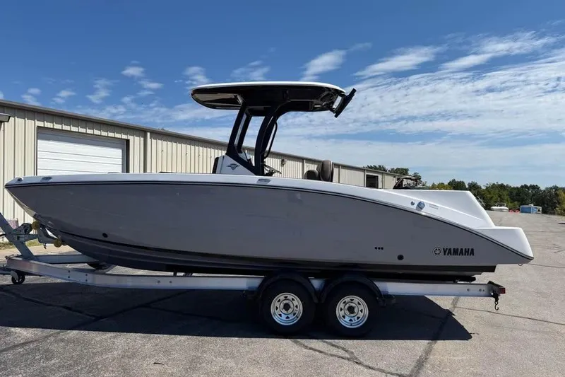 Slide: The Image of 2026 Yamaha Boats 255 FSH Sport H on trailer, parked outdoors under blue sky. - 4