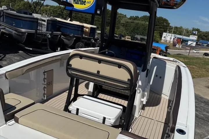 Slide: The Image of 2026 Yamaha Boats 255 FSH Sport H interior with seating and storage, displayed outdoors. - 8