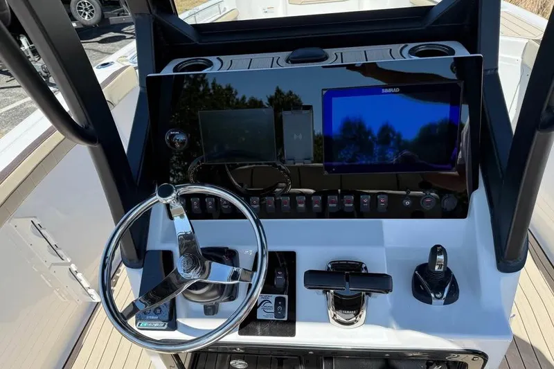 Slide: The Image of 2026 Yamaha Boats 255 FSH Sport H dashboard with steering wheel and navigation controls. - 9