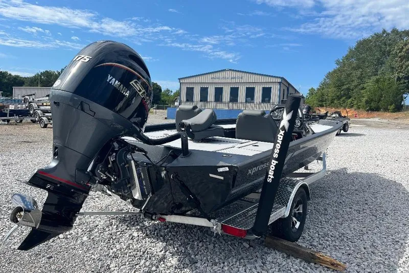 Slide: The Image of 2026 Xpress H20 Bass boat with Yamaha engine on gravel lot. - 3
