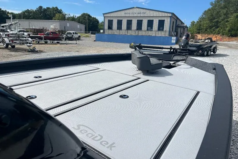 Slide: The Image of 2026 Xpress H20 Bass boat with SeaDek flooring at a marina. - 5