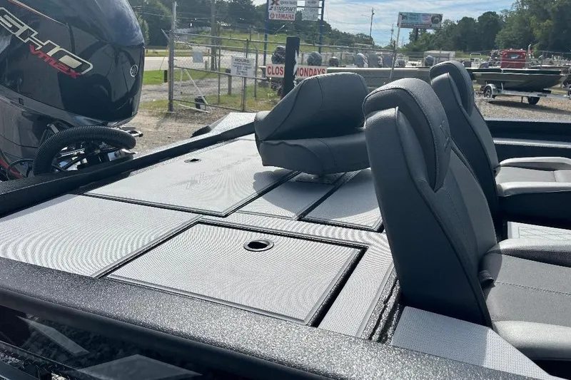 Slide: The Image of 2026 Xpress H20 Bass boat with sleek seating and powerful engine, parked outdoors. - 6