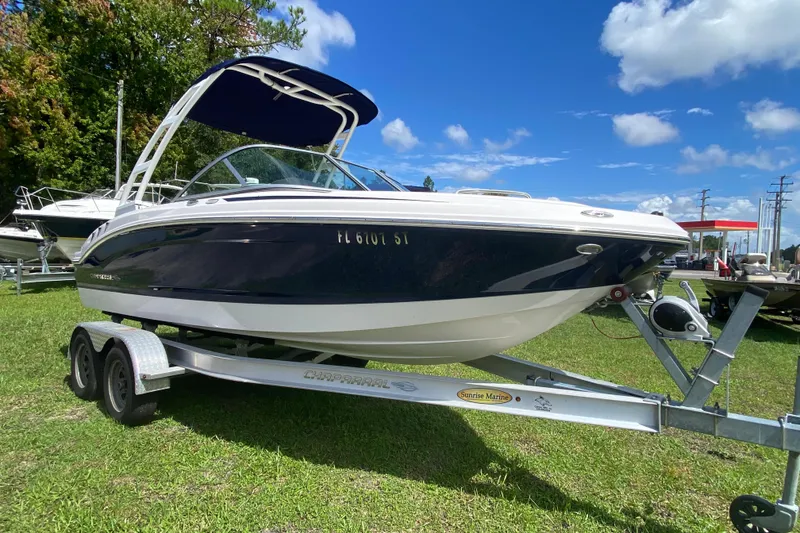 Slide: The Image of 2020 Chaparral 19 SSi boat on trailer, parked on grass under blue sky. - 2