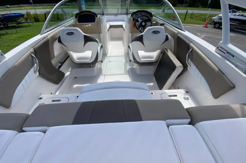 Slide: The Image of 2020 Chaparral 19 SSi boat interior with white and gray seating, steering wheel, and dashboard. - 7