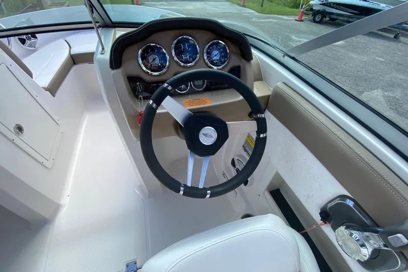 Slide: The Image of 2020 Chaparral 19 SSi boat dashboard with steering wheel and gauges. - 8