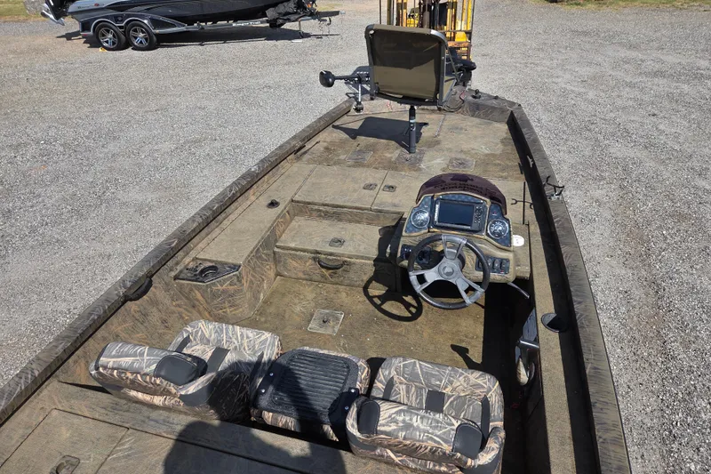 Slide: The Image of 2021 G3 Sportsman 1710 boat interior with camouflage seats and steering console. - 13