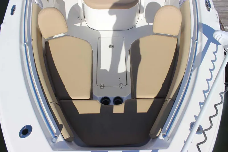 Slide: The Image of 2017 Key West 239 FS boat interior with beige seating and storage compartment. - 12