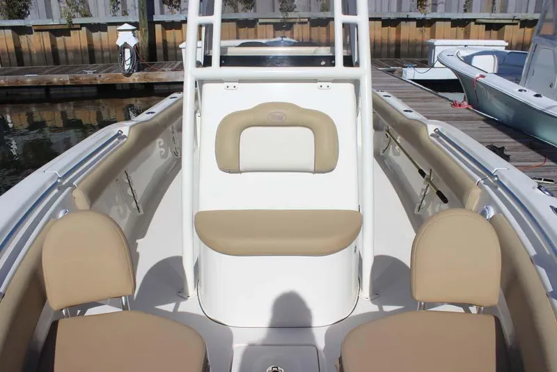 Slide: The Image of 2017 Key West 239 FS boat interior with beige seating at dock. - 13