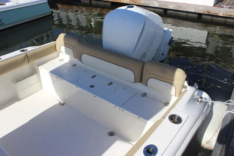 Slide: The Image of 2017 Key West 239 FS boat interior with Yamaha engine, docked on calm water. - 15