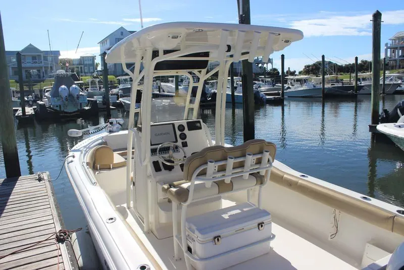 Slide: The Image of 2017 Key West 239 FS boat docked at marina, featuring center console and T-top. - 5