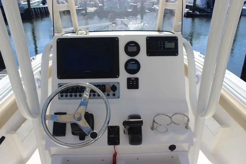 Slide: The Image of 2017 Key West 239 FS boat dashboard with steering wheel and electronic controls. - 7
