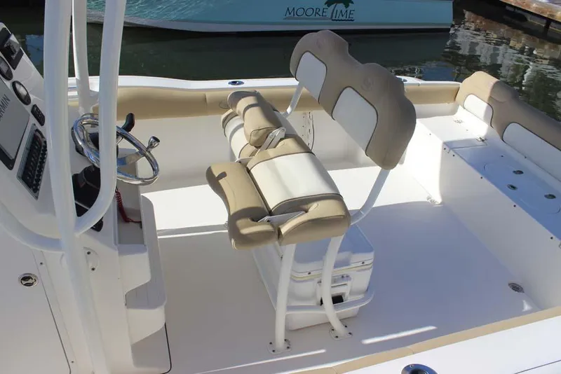 Slide: The Image of 2017 Key West 239 FS boat interior with beige seating and steering console. - 8