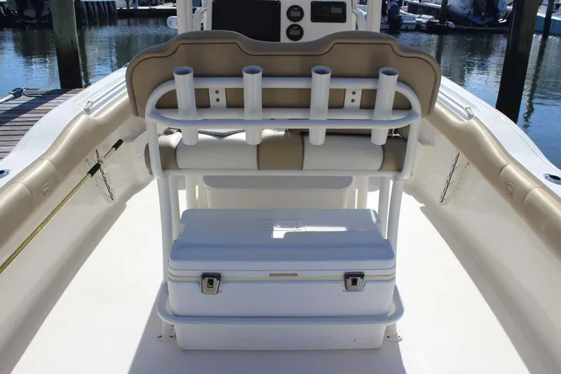 Slide: The Image of 2017 Key West 239 FS boat interior with rod holders and cooler on deck. - 9